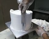 A picture of step 6 of 8 inch tall chocolate brownie cake.