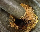 A picture of step 1 of Cambodian grilled chicken over rice.