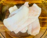 A picture of step 1 of Hake in the oven under a cheese crust.