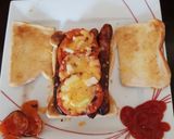A picture of step 2 of My Sausage, Tomato, Cheese + Onion Toast. 😁.