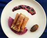 A picture of step 9 of Znoud-el-sit with creamy choco hummus filling and red grape sauce.