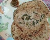 A picture of step 5 of Mooli ki parathi with achar aur butter.