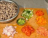 A picture of step 2 of Lobia chilla loaded with veggies.
