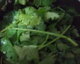 A picture of step 2 of Palak panch dal khichdi tempered with burnt garlic.