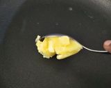 A picture of step 7 of Coconut Mawa balls immersed in Creamy Coconut saffron milk.