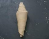 A picture of step 9 of Shankh/ conch shaped layered paratha.