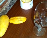 A picture of step 3 of Mango milk shake with chocolate and nuts.