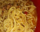 A picture of step 6 of Seafood indomie with fish chunks.