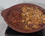 A picture of step 4 of Beans and rice sizzler in a clay pan.