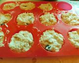 A picture of step 6 of COCONUT MUFFINS with blue berries and chocolate chips.
