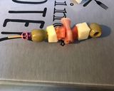 A picture of step 5 of Appetizer Skewers with Green Olives, Tomato, Prosciutto, and Pyrenees Cheese.
