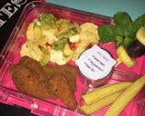 A picture of step 3 of Nachos, crumbed chicken pieces, mini corn cobs, pineapple grape and mint fruit skewer.
