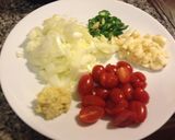 A picture of step 1 of Dandelion Ka Saag. with grape tomatoes and blue cheese.