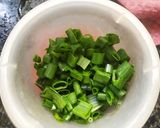 A picture of step 1 of Prawn curry with spring onion.