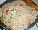 A picture of step 2 of Chinese rice nd veggies are sauce.
