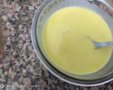 A picture of step 5 of Coconut Mawa balls immersed in Creamy Coconut saffron milk.