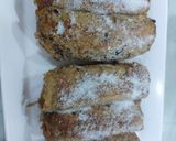 A picture of step 3 of Banana cinnamon bread rolls with chocolate syrup garnish.