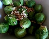 A picture of step 2 of My Roasted Sprouts in orange,crushed Walnuts and Cranberry sauce.
