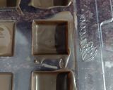 A picture of step 1 of Walnut phirni in chocolate square.