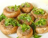 A picture of step 3 of Hummus stuffed cheesy mushrooms.