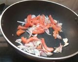 A picture of step 2 of Maggi with tomato onion.