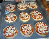 A picture of step 2 of Mini pizza with speghetti.