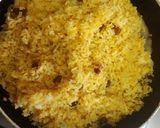 A picture of step 3 of Turmeric rice with raisins.