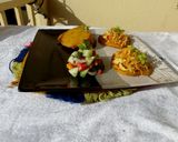 A picture of step 7 of Patacones or Tostones with minced chicken topping.