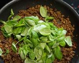 A picture of step 3 of My version of Thai Basil Beef (Pad Ka Prao) with dried chillies, topped with fried eggs.