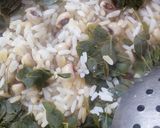 A picture of step 6 of Rice and beans with moringa leaves.