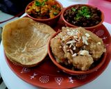 A picture of step 5 of Ashtami Bhog Thali (Halwa, Puri, Kala Chana).