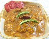 A picture of step 4 of Chicken 65 with gravy.