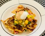 A picture of step 10 of Loaded Nachos with Mango Salsa, Sour cream and cheese sauce.
