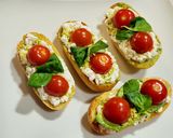 A picture of step 5 of Toasts with Cottage Cheese, Cherry Tomatoes, Guacamole, and More.