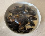 A picture of step 3 of Mussels in a white wine, butter, garlic and parsley sauce.