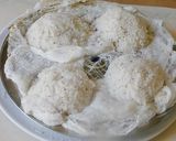 A picture of step 4 of Sweet Puttu (steamed rice cake from Kerala) with coconut.