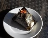 A picture of step 4 of Onigiri with salmon flakes.