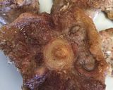 A picture of step 2 of Braised oxtail in a red wine reduction .
