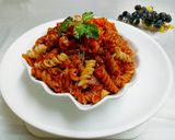 A picture of step 7 of Cheesey spiral Pasta in red sauce.