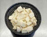 A picture of step 7 of Steamed tofu with sweet soy dressing sauce and spring onions.