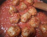 A picture of step 6 of Mozzarella pork meatballs over spaghetti.