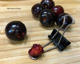 A picture of step 5 of #HowTo “Pit Cherries” with a binder clip? - Tuesday Tip.
