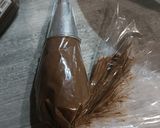 A picture of step 13 of Mardi Gras Chocolate Donuts.