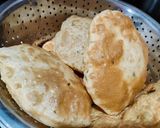 A picture of step 7 of Kasuri methi poori with potato curry.