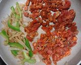 A picture of step 2 of Pork Al pastor with sauteed onions and peppers.