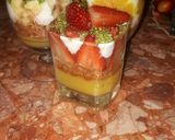 A picture of step 12 of Kunafa and Qashtalia Decorated with Oranges, Strawberries, and Bananas.