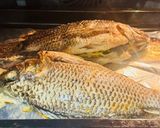 A picture of step 4 of Tilapia baked with carrots and onions.