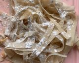 A picture of step 1 of Left over chowmien wrapped with torn Manda patti strips.