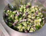 A picture of step 7 of Composed Salad with Black Tomatoes, Cucumber, Red Onion, Feta, and Parsley.
