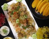A picture of step 13 of ChatpatiBombay biryani with tang twist, yogurt salad, mango, apple cubes.
